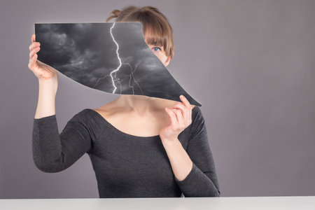 Women psychology. Reflection emotions in hands of woman. Thunderstorm as metaphor for a depression....