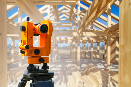 Optical theodolite of surveyor. Optical theodolite on a wooden frame background. Equipment for...