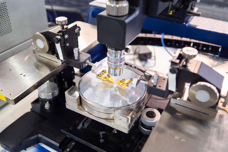 PCB production. Silicon wafers for production of microelectronics. System Wafer Testing. Silicon plate under microscope. Microprocessor manufacturing process. Laser equipment for system wafer testingの写真素材