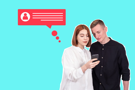 Guy and girl with phone. Social media communication concept. Correspondence via telephone. Young couple is texting via smartphone. Social media app. Man and woman on turquoise background.の写真素材