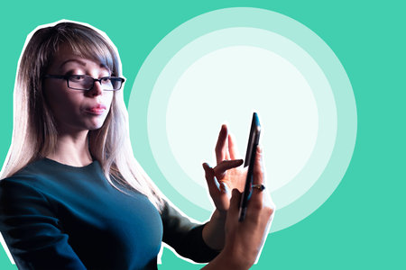 Businesswoman with phone. Woman entrepreneur on green background. Long-haired woman uses a...