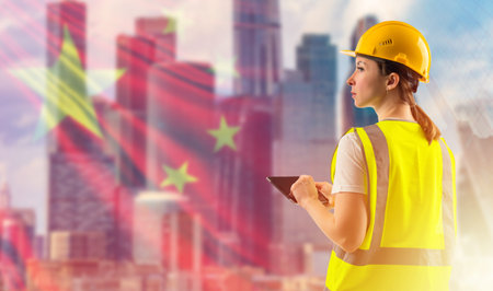 China architecture concept. Woman builder on background of skyscrapers. Woman architect. She works...