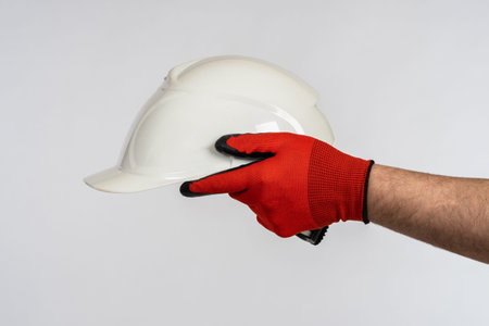 Construction helmet in the hands of a worker. Symbol of construction, repair. Protective uniform....