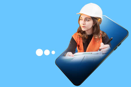 Website or application architect concept. Girl architect draws blueprints. Portrait builder in smartphone screen. Construction company website. Mobile apps for architects. Architectural bureau appsの写真素材