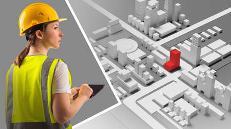 A female builder and a mock-up of the city. Building design. Urban architecture. A female architect is working on a residential building project. A girl in a construction helmet. 3d imageの写真素材