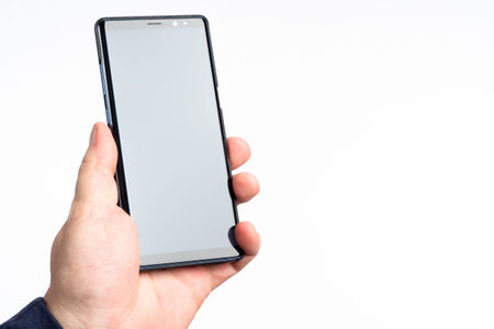 Phone in hand. Man hands off by phone. Smartphone for application demonstration. Black modern...
