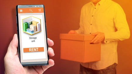 Rent storage space. Storage Unit inscription in smartphone screen. Storage Unit rental via phone....
