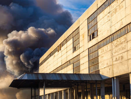 Black smoke from fire. Fire extinguishing. Salvation services. Big fire in the industrial zone. Smoke from a burning building. Firefighting.の写真素材