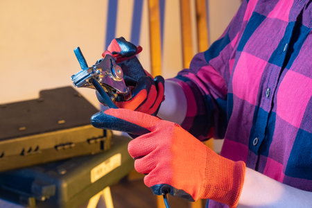 Wire stripping tool. Man removes sheath from wires. Working with electrical wiring. Preparing...