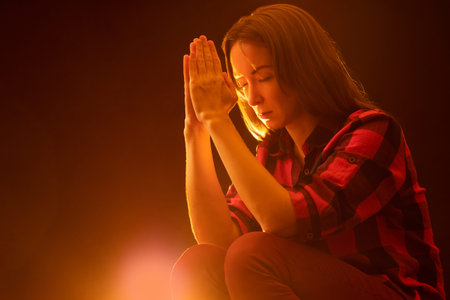 Woman praying. Portrait of Religious Girl. Concept - she is Orthodox Christian. Orthodox girl...