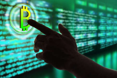 Blockchain technology. Bitcoin mining. Man's hand reaches for bitcoin logo. Mining cryptocurrencies using server hardware. Blockchain elements programming. Crypto tech programming. Bitcoin technologyの写真素材