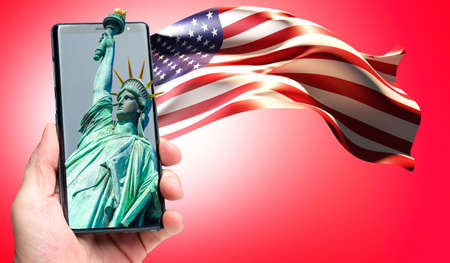 USA symbols on phone. Human hand with flag and statue of liberty. Statue of Liberty in mobile app. Visualization of America flag on red background. USA symbols. Statue of Liberty symbolizes New Yorkの写真素材