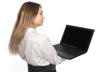 Woman laptop. Girl stands with open laptop. Computer is portable in hands of girl. Notebook screen...