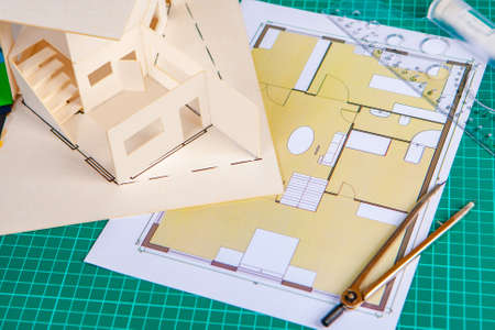 Layout of a house with a flat roof. Layout of premises. Architect's desk. Redevelopment. Creation of architectural projects. Layout of the house next to the floor plan. Design of country houses.の写真素材