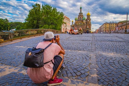 Saint Petersburg. Russia. Savior on Spilled Blood. Tourists take pictures on the background of temple. Cathedral of Resurrection of Christ. Tourist season in St. Petersburg. Photographer. 08/16/2017のeditorial素材