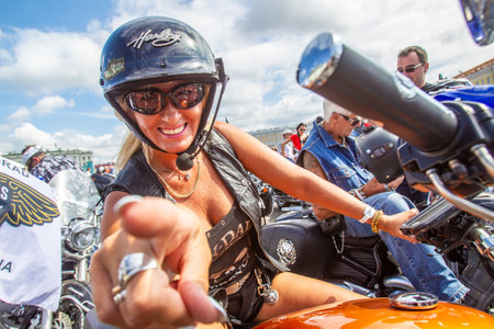 Saint Petersburg. Russia. Biker girl. Holiday Bikers. Girl on a motorcycle posing to the camera. Women of St. Petersburg. Motorcycle festival in the Russian city. Vacation in Russia. 04.08.2018のeditorial素材