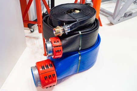Hoses. Fire emergency hose made of synthetic fibers. Three Hoses lie on top of each other. Hoses of different diameters. Flexible hose manufacturing. Watering equipment. Goods for the garden.の写真素材