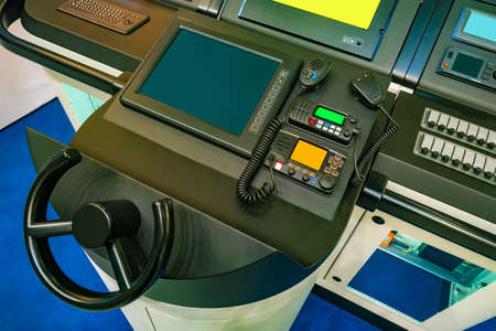 Captain's bridge on a yacht. Steering wheel. Concept - boat control. Radio station. Steering wheel for yacht control. Radio communication on the ship. Professional ship radio station. Communicationの写真素材