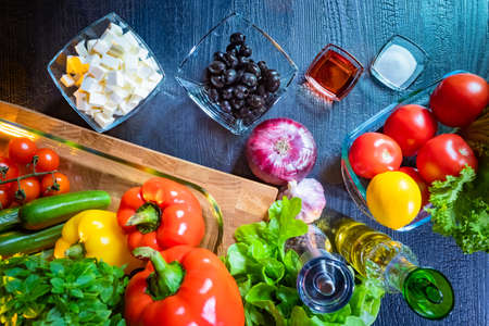 Ingredients for making Greek salad. Salad ingredients top view. Paprika. Chees Feta. Black olives. Tomatoes Onion. Concept - learn how to cook Greek salad. Be a cook. Do-it-yourself cooking.の写真素材