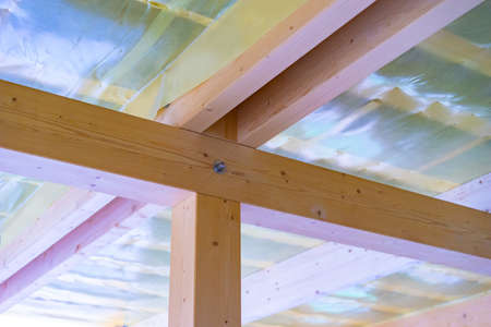 A bolt connects beams in wood. Fixture for the frame house. Joining the beam with a bolt. Fasteners for wooden supports. Overhaul in a wooden house. Construction of private houses.Housing constructionの写真素材