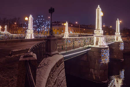 Russia. Bridges of Saint Petersburg. Christmas highlight of St. Petersburg. Neva. Seven bridges. Winter Petersburg. Night. The bridge across the Neva. Canals of Russian cities. Tourism in Russia.の写真素材