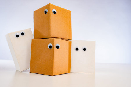 Emoji is perplexed. The concept of lost postal parcels. Paper cubes with eyes. Boxes with bulging...