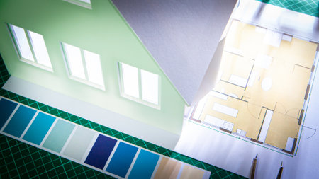 Color of the facade of the building. Concept - painter services during construction. Layout of the house next to the drawing. Color scheme on the architect's desk. Choice of color for home decorationの写真素材