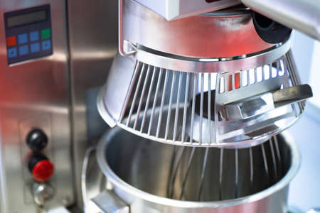Industrial mixer. Mixer close up. Whisk industrial mixer. Whipping. Equipment for the restaurant. Food production. Sale of equipment for small businesses. Catering business. Dining room.の写真素材
