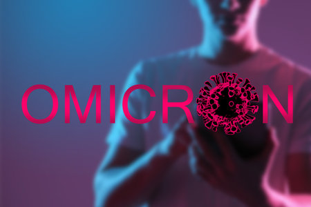 Omicron COVID-19 variant. Coronavirus mutation. Concept for lockdown due to delta plus strain. New Omicron lockdown. SARS-CoV-2 symbol in front of blurred man. COVID infection epidemicの写真素材