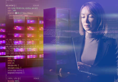 Sysadmin woman. Sysadmin with laptop. System administrator portrait double exposure. Server hardware programming. Creation of software for data center concept. Code and server next to girl.の写真素材