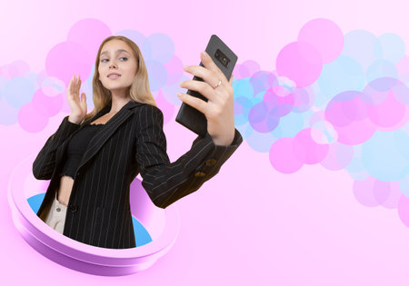 Girl takes selfie. Woman with phone on pink. She calls on video call. Woman photographs herself on...