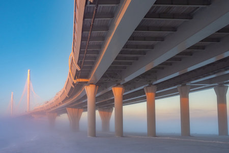 Bridge is over frozen river. Overpass supports in ice. Bridge construction concept. Road...
