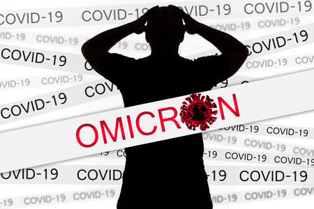 OMICRON Virus quarantine. Lockdown due to COVID-19 variant Coronavirus concept. Silhouette of man clutching his head. Delta plus contagious human strain. OMICRON tapes. Mutated SARS-CoV-2. 3d image.の写真素材