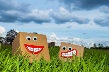 Cardboard boxes for packaging of goods. Corrugated box production. Cartons in the open. Carton stand on the grass. Dispatch of goods. Sale of packaging materials. Warehouse in nature.の写真素材