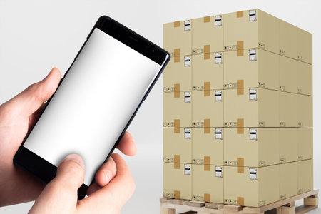 Business logistics mock up. Phone template with white screen. Pallet with boxes on light background....