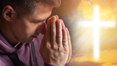 Catholic is praying. Believer man next to cross. Religious cross in front of guy. Christian is...