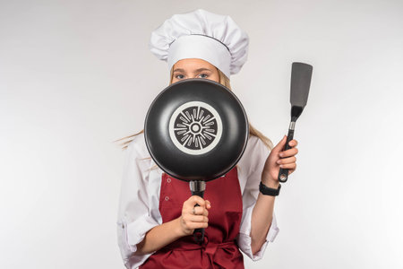 Chef cook restaurant. Cook covers his face with frying pan restaurant chef looks at camer Frying pan...