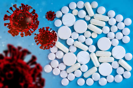 Medicines for virus. Virus molecules next to pills. Virus molecules on blue background. Medicines for treatment of disease. Vitamins different shapes top view. Formacological preparationsの写真素材