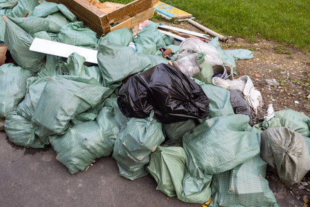 Construction garbage. Garbage bags next to lawn. Waste from construction works. Lots of...
