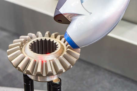 3d scanning. Three-dimensional scanner for metal parts. Laser scanner during operation. Metal part inside 3D scanner. Scanning complex metal part. Process of copying volumetric objects.の写真素材
