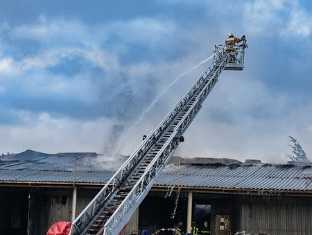 Boom crane with firefighters. Fragment fire truck with retractable crane. Fire extinguishing from...