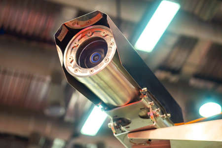 Vandal-proof camera. CCTV under roof of building. Security camera with metal case. Metal security camera. Anti-vandal video surveillance system. Anti-vandal CCTV equipment. Video recording systemsの写真素材
