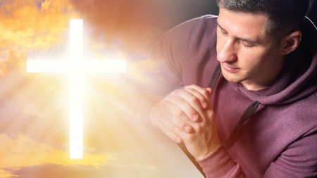 Praying Christian. Praying man closed his eyes. He crossed his palms for prayer. Glowing Christian...