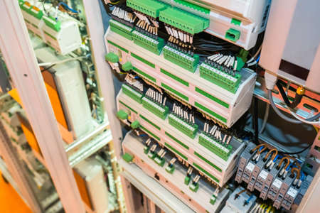 Electrical engineering concept. Electrical cabinet with many automatic machines. Electrical equipment close-up. Power control panel. Electrification equipment. Power switches with many wires.の写真素材