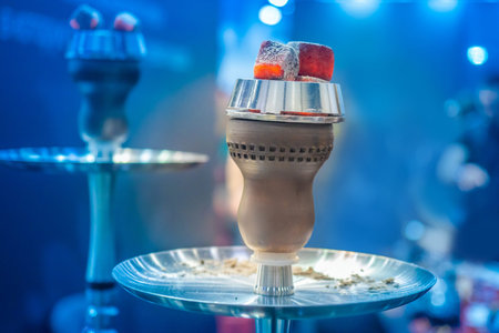 Chillum. Coconut coals for hookah. Accessories for Hooka. Hot coals on bowls of hookahs.Hookah bar....