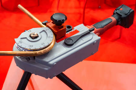 Mechanical pipe bender. Device for bending pipes. Equipment for production of copper tubes. Bending copper tube with equipment. Tools for installation of pipelines. Tube bending deviceの写真素材