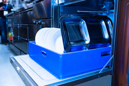 Equipment for restaurants. Dishwasher. Equipment for washing dishes. Purely. Plates with water for a dishwasher. Cleaning. Electrical equipment for the kitchen. Catering business. Horeca. Kitchen.の写真素材