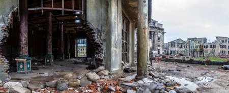 The destroyed buildings. Abandoned city. The streets of the ruined city. The ruins of old buildings. The ruins of the destroyed city. Dra in the old building. A hole in a collapsed building.Apocalypseの写真素材