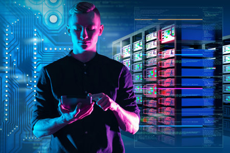 Young system administrator. Data Center Manager. Storage work In information processing. Data center administrator. Hosting provider manager. Sysadmin guy with tablet. Sysadmin on serversの写真素材