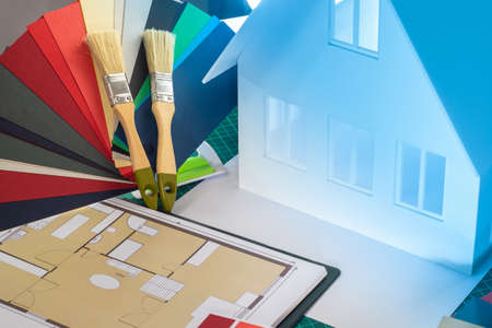 Concept - color of the building. Layout of the house. Molar brushes. Painting of walls. Painting works in construction. Services of painters during construction. Palette and layout of the building.の写真素材